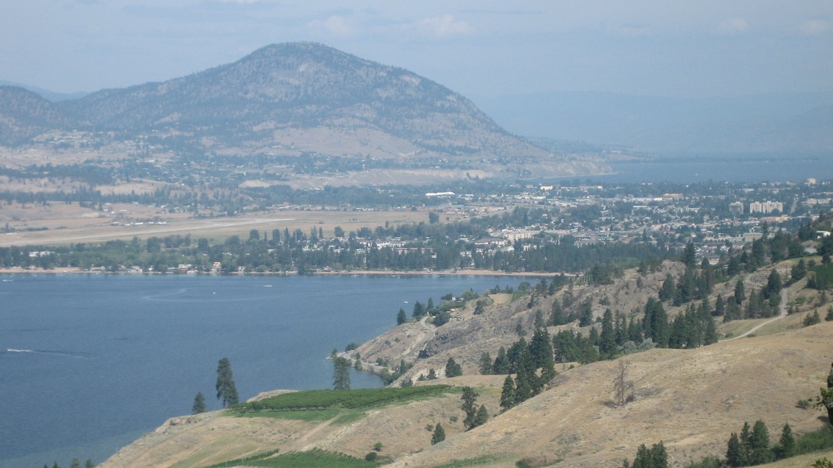 Penticton and Skaha Lake viewed across rural hillside land