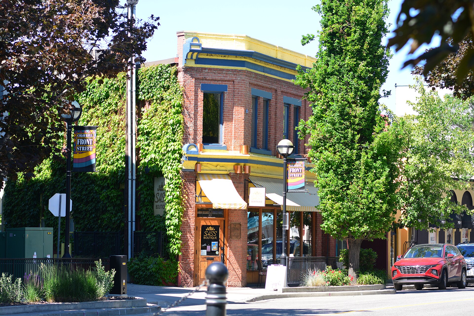 Red-brick heritage commercial building covered partly in green ivy on Front Street in downtown Penticton